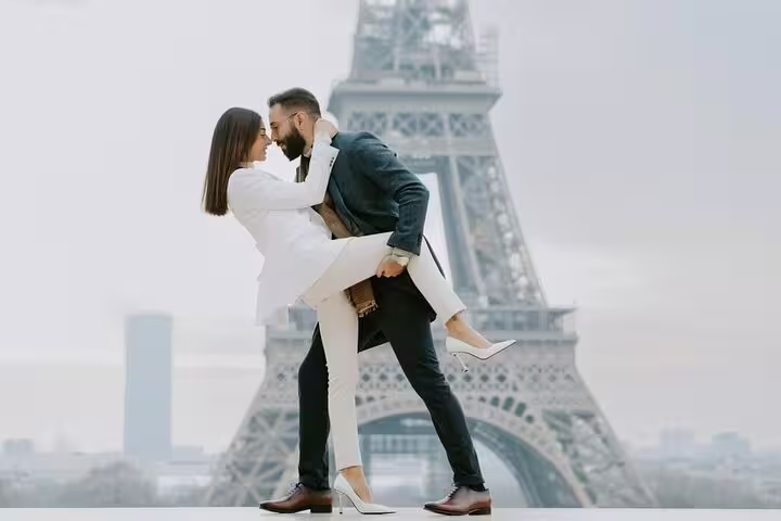 Couple embracing in front of the Eiffel Tower during a professional Paris photoshoot