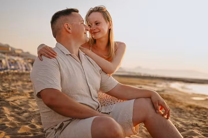 Smiling couple enjoying a romantic beach moment during a private photoshoot in Gouves.