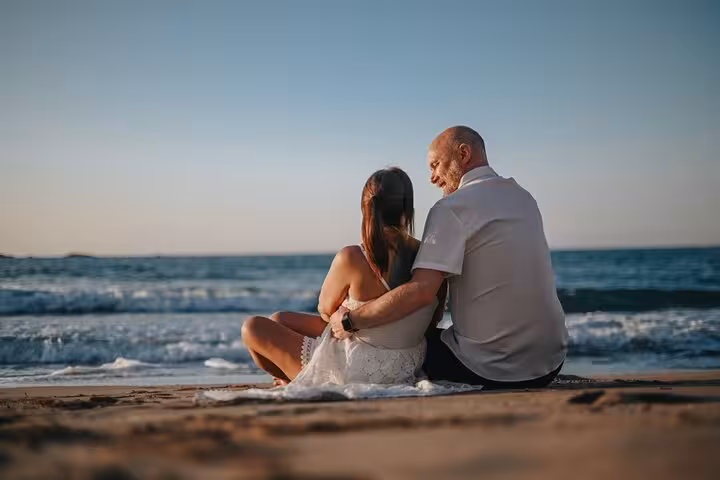 Couple enjoying a romantic beach sunset during a private photoshoot in Hersonissos, perfect for capturing memories.