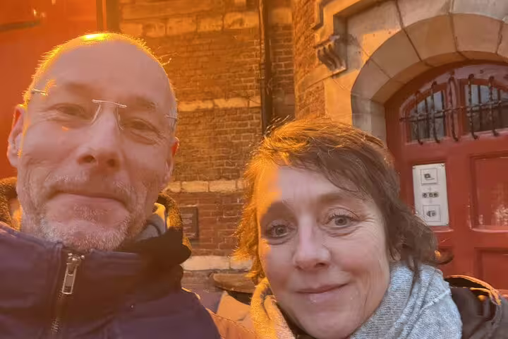 Couple smiling together on a romantic evening walk in Amsterdam's historic city center