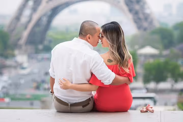 Couple sharing romantic moment in front of Eiffel Tower in Paris
