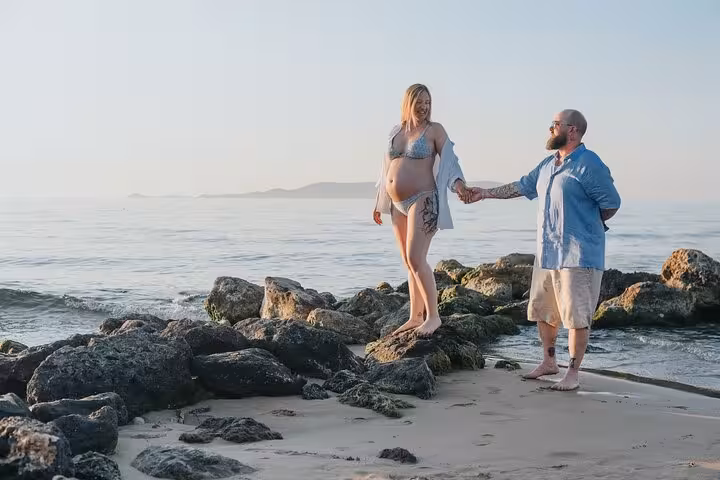 Couple enjoying a romantic photoshoot on a Gouves beach at sunset, capturing intimate moments by the sea.