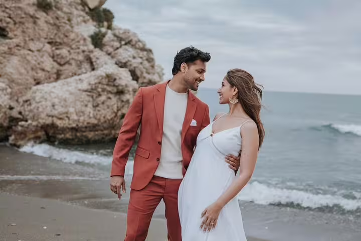 Couple enjoying a romantic photoshoot on a scenic Marbella beach, perfect for capturing memorable moments.