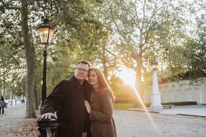 Couple enjoying a romantic sunset walk in a London park during a private travel photographer tour.