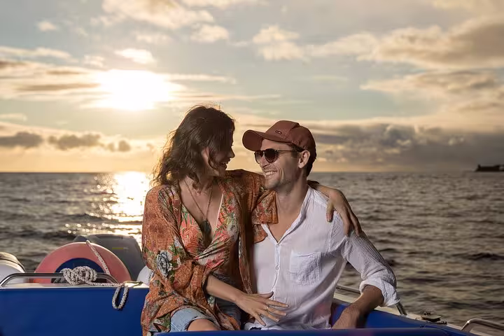 Couple enjoying a romantic sunset on a private cruise, perfect for adventure escape and intimate experiences.