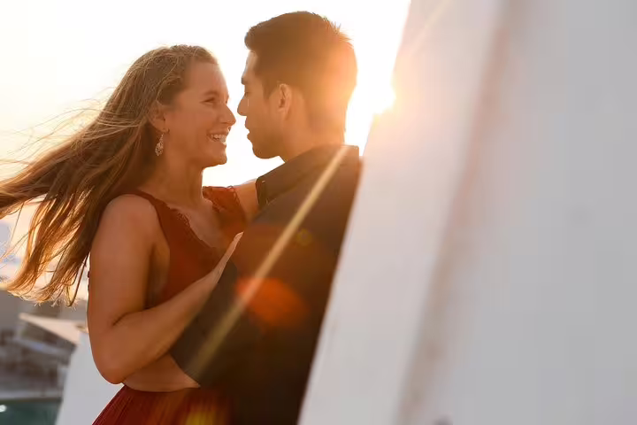 Couple enjoys romantic sunset moment on Santorini tour, capturing love and light with a personal vacation photographer.