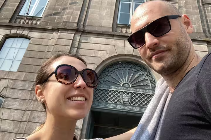 Couple smiling in sunglasses on a romantic walking tour in Porto