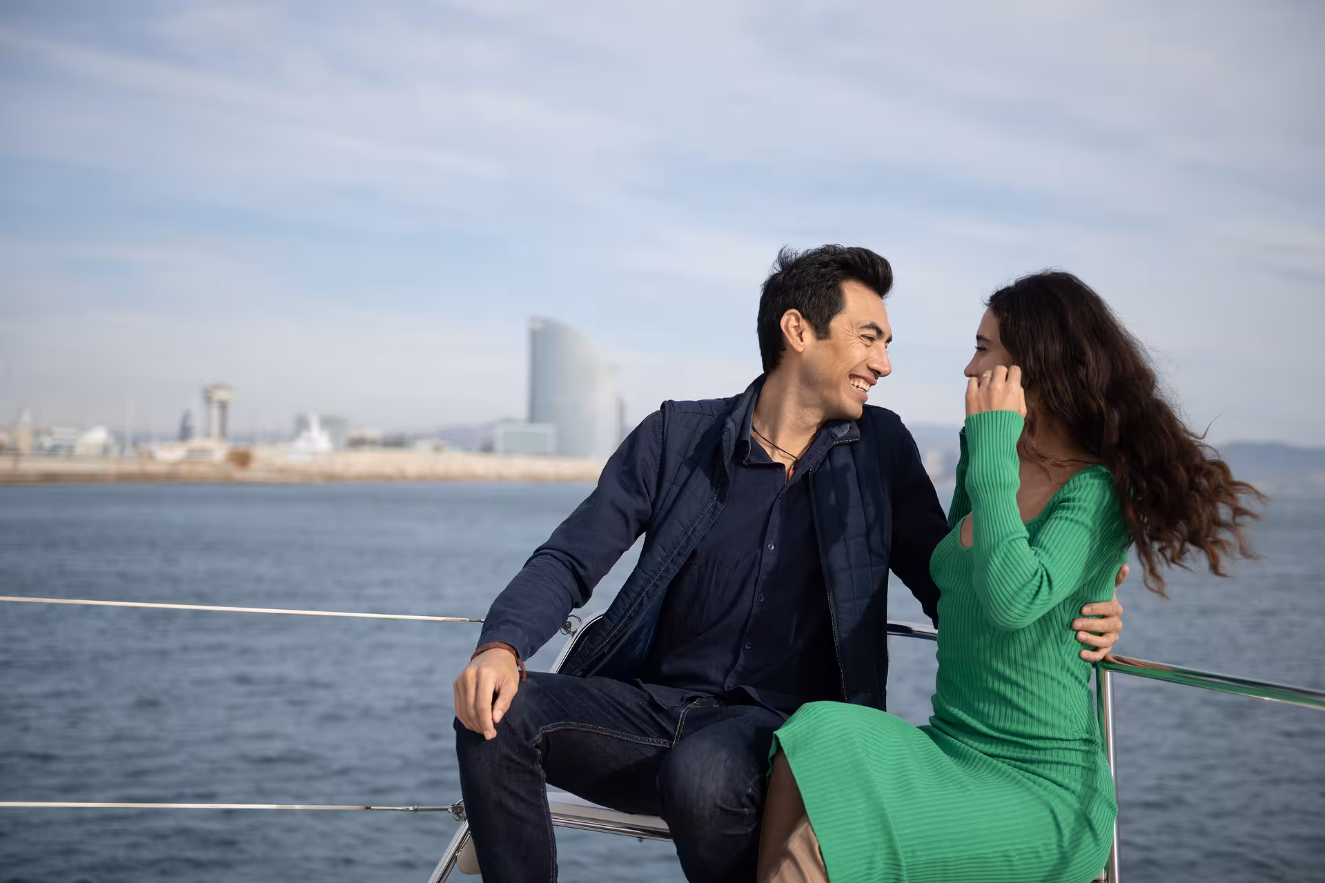 Couple sharing a romantic moment on a private yacht in Barcelona, ideal for a marriage proposal cruise