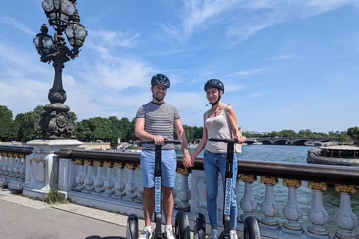Couple on Segways at Pont Alexandre III overlooking the Seine, Paris Segway tour with Seine River cruise ticket