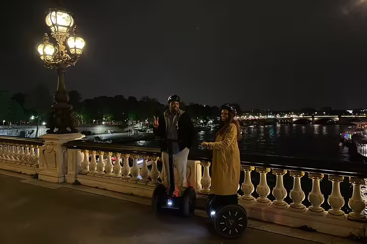 Couple on Segways by the Seine at night near Pont Alexandre III, Paris by night Segway tour with local guide