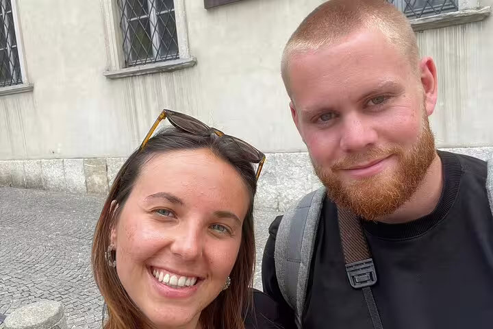 Couple smiling during self-guided murder mystery walking tour in Como, Italy
