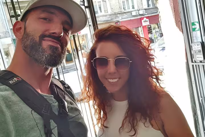 Couple smiling during a self-guided walking tour in Sofia city street