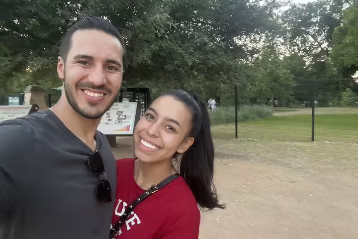 Smiling couple taking a selfie during an outdoor walking tour in Austin park