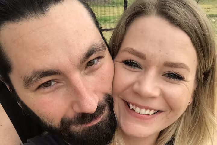 Smiling couple taking a selfie outdoors during an Austin walking tour