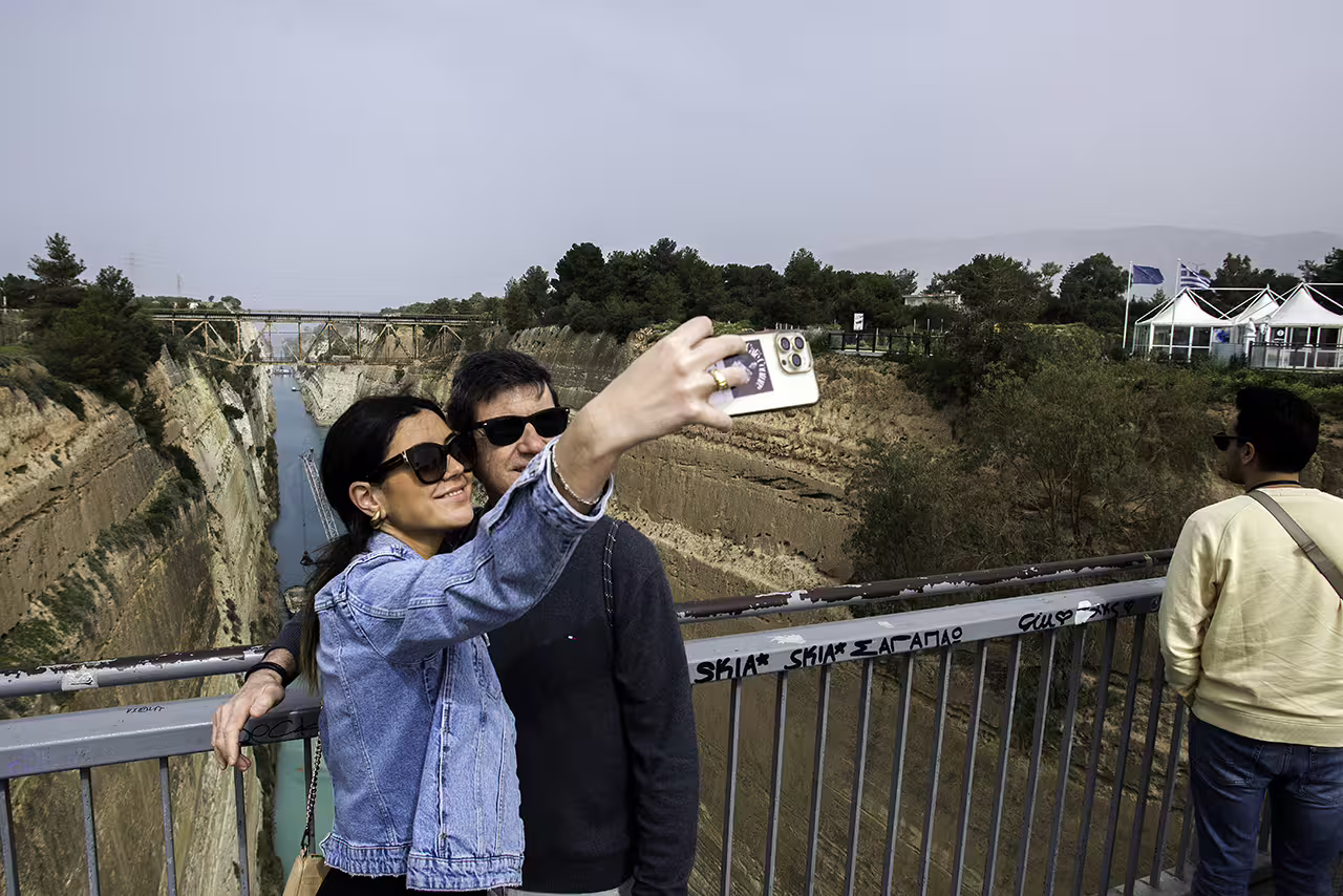 Couple taking a selfie at the Corinth Canal lookout, a scenic stop on the Ancient Corinth and Nafplion guided tour
