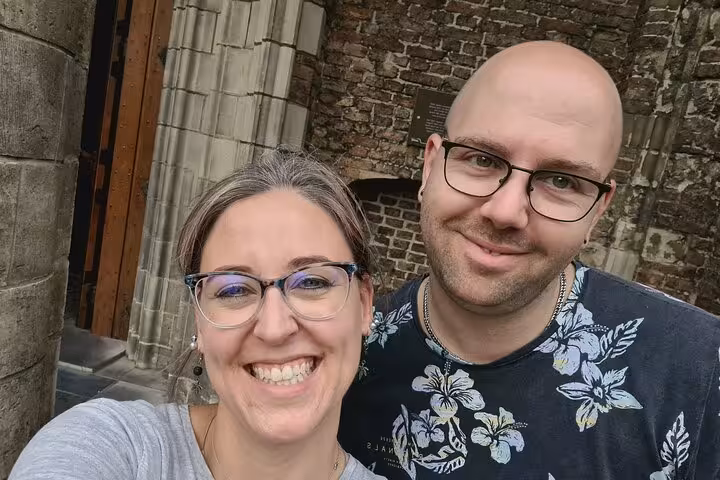 Couple smiling during self-guided walking tour in Delft historic city center
