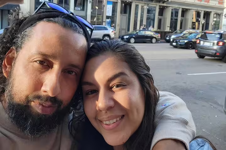 Couple taking a selfie on a sunny urban street in the Gaslamp Quarter, San Diego