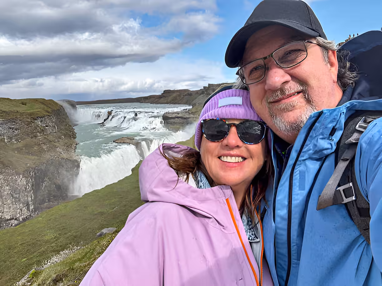 Happy couple taking a selfie at Gullfoss waterfall on a private Golden Circle tour in Iceland