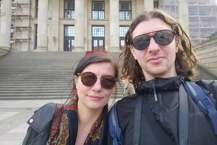 Couple taking a selfie in front of a historic Berlin building during a WWII walking tour