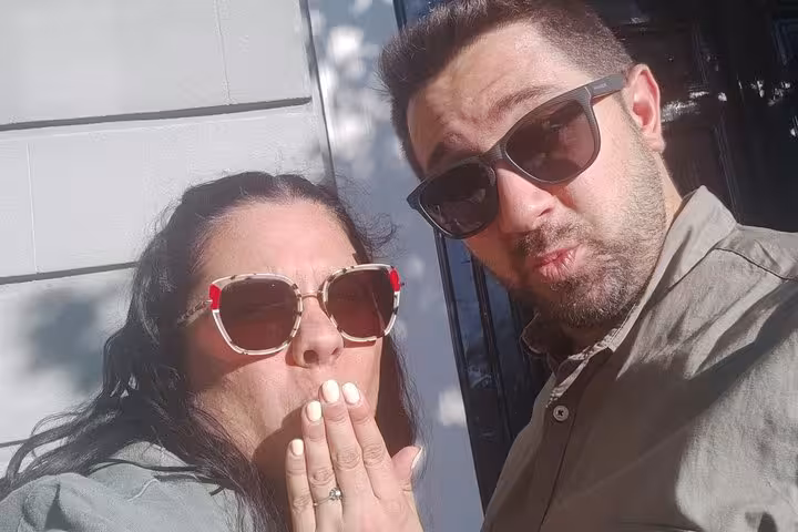 Couple taking a selfie at night during a ghost walking tour in Madrid