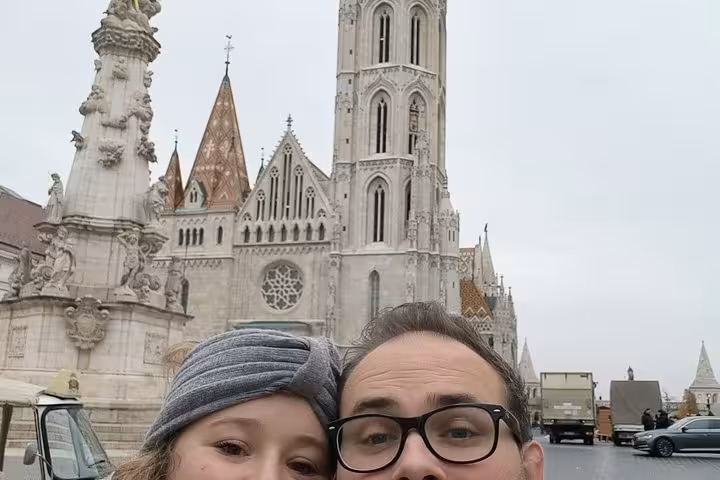 Couple taking selfie in front of Matthias Church at Buda Castle, Budapest