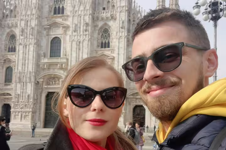 Couple taking selfie in front of Milan Cathedral during self-guided walking tour