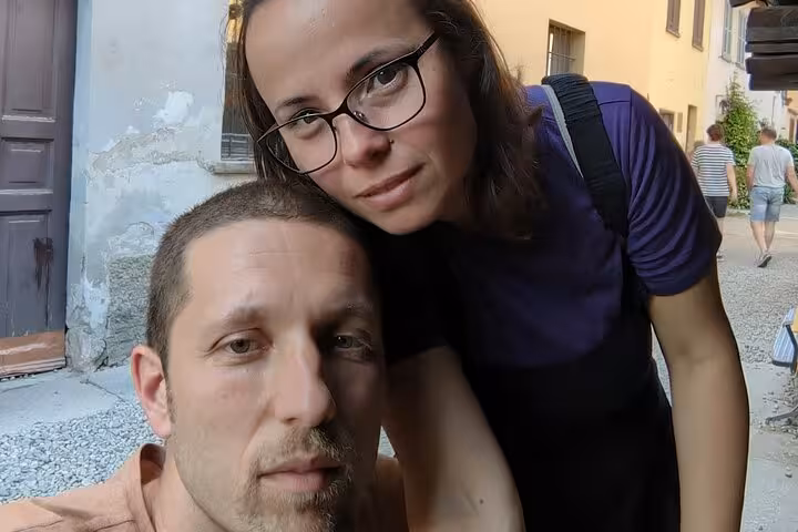 Couple taking a selfie on a Milan street during a walking tour of the Navigli district