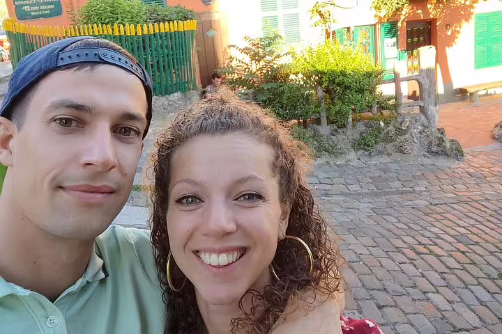 Couple smiling together on cobblestone street in Montmartre Paris during walking tour