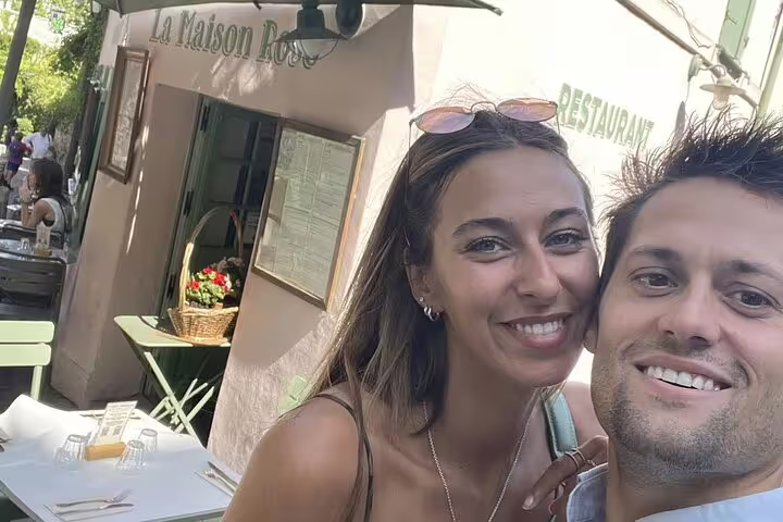 Couple smiling at outdoor café terrace near La Maison Rose restaurant in Montmartre Paris