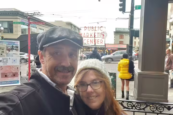 Couple smiling in selfie at Pike Place Public Market Center in Seattle