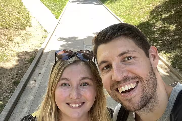 Smiling couple taking a selfie outdoors during a self-guided walking tour in Sibiu Old Town