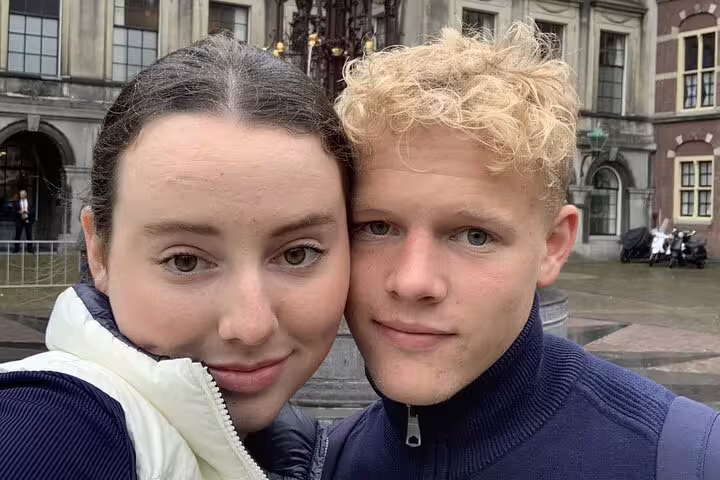 Couple taking a selfie in front of a historic building in The Hague old town