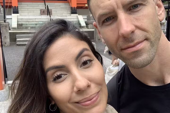 Couple taking a selfie at a historic Tokyo shrine during a guided walking tour