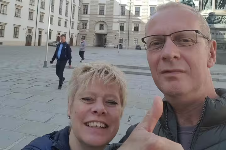 Couple taking a selfie in a historic Vienna plaza during a guided walking tour