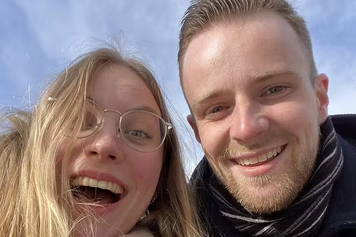 Smiling couple taking a selfie outdoors at Vigeland Park Oslo on a sunny day