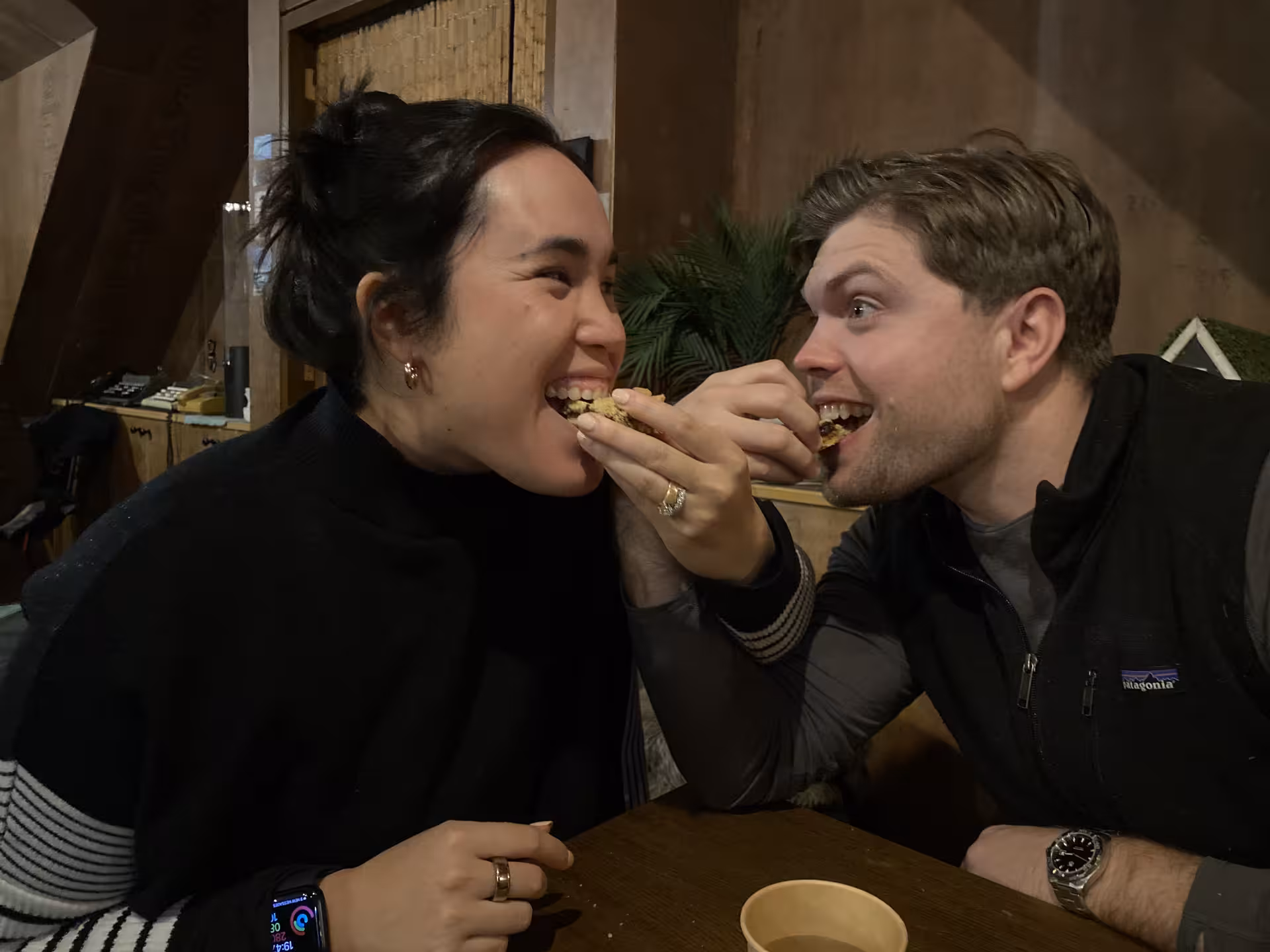 Couple laughing while sharing a bite of traditional Icelandic food during a guided food tour