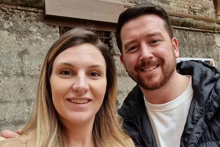 Couple smiling together on a self-guided walking tour in Bologna, Italy