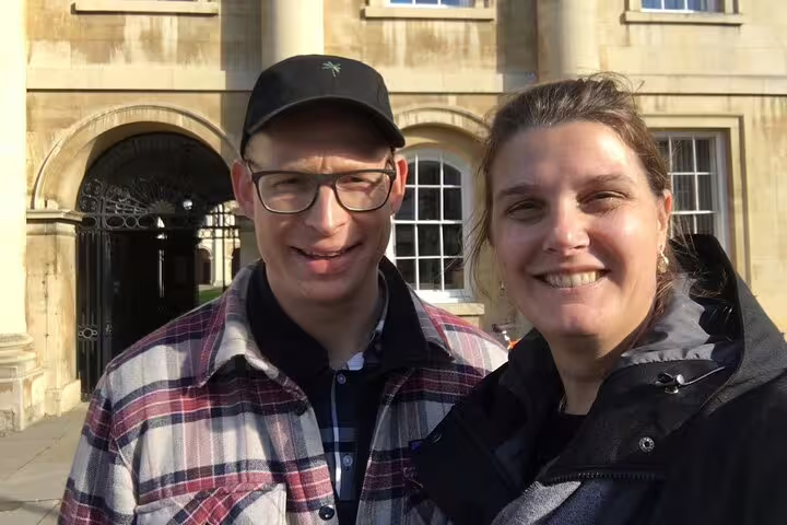 Couple smiling in front of historic Cambridge building during self-guided tour