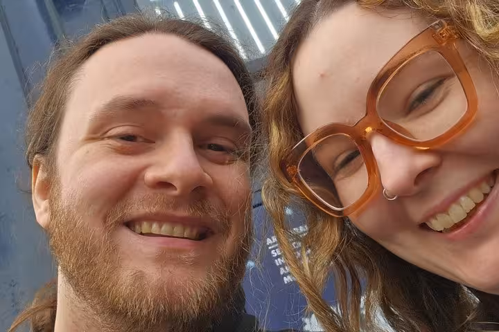 Two smiling people on a Manchester street art self-guided tour