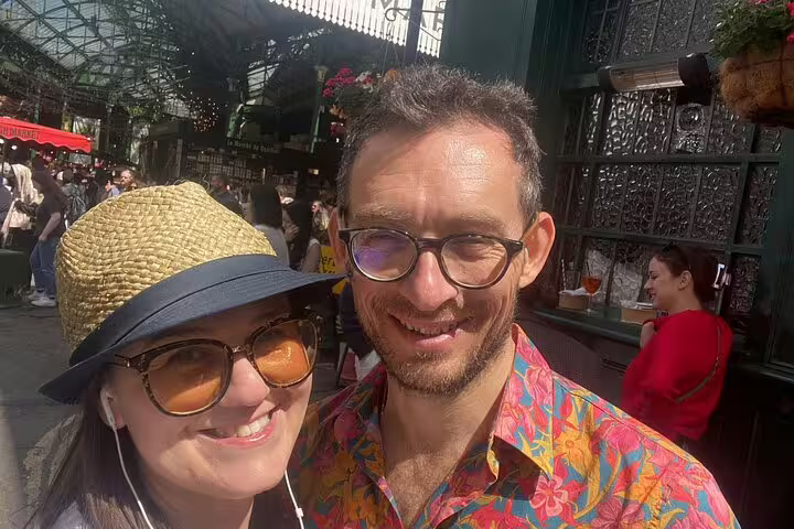 Couple smiling at Southwark Borough Market on a sunny day in London