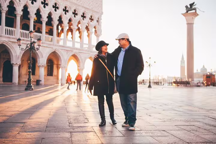 Couple walking in St Mark’s Square at sunrise, Venice, captured by professional photographer on tour