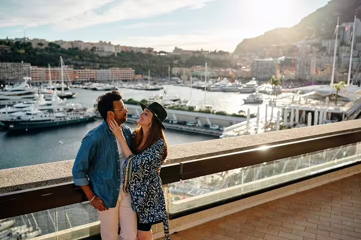 Couple embracing with a beautiful sunset view of Cannes harbor, highlighting a romantic photoshoot experience.