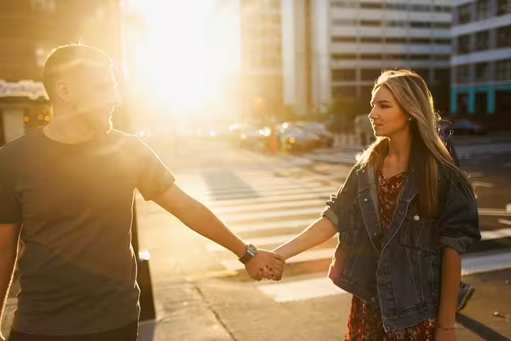 Couple holding hands at sunset on a Melbourne city street, captured on a private travel photographer tour