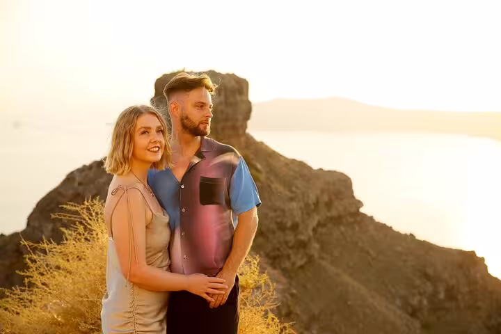 Couple poses at sunset with stunning Santorini cliffs, enjoying a unique travel photography experience.