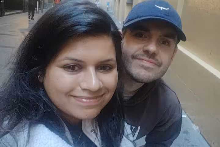 Couple smiling together on a city street during Sydney ghost walking tour