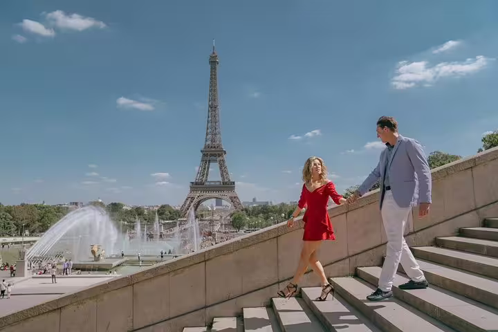 Couple on Trocadéro stairs with Eiffel Tower view, Paris proposal photographer capturing romantic engagement photos