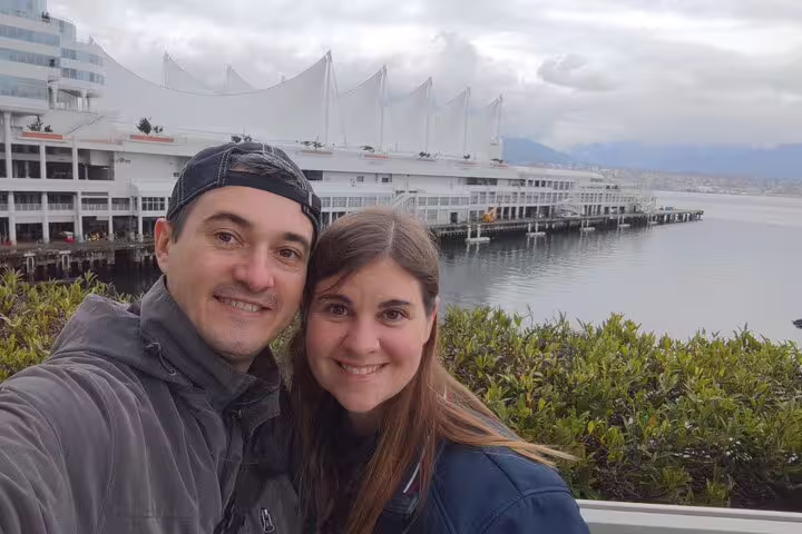 Couple selfie with Canada Place and harbour backdrop, exploring clues on the Vancouver Gastown scavenger hunt