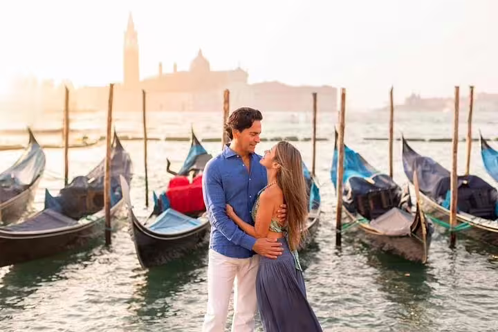 Couple Venice city portrait session by gondolas at sunrise, candid romantic photos in St Mark’s Basin