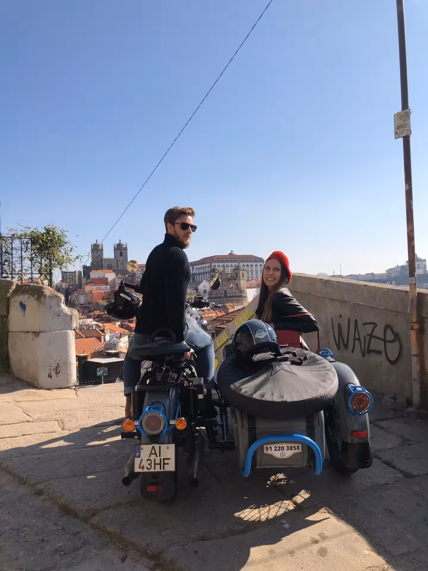 Couple on vintage sidecar overlooking Porto skyline and Sé Cathedral viewpoint on afternoon tour Porto