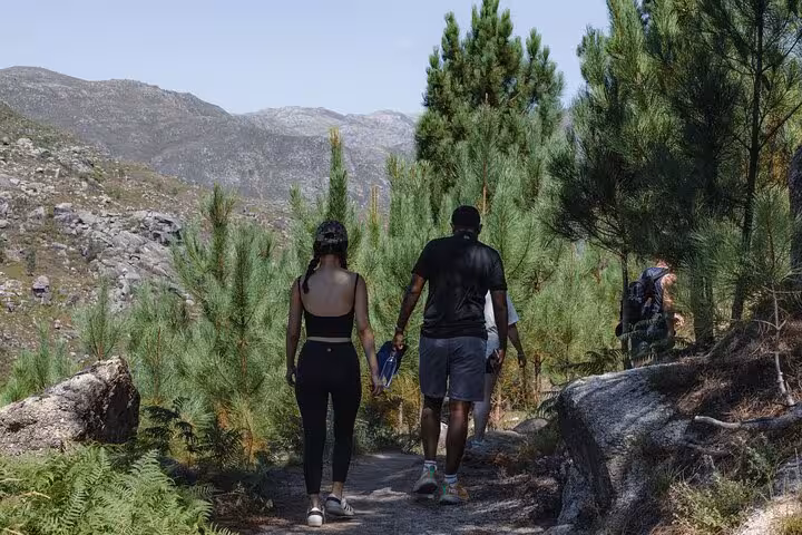Couple walking along a forested path in Geres National Park, enjoying the tranquil natural surroundings.